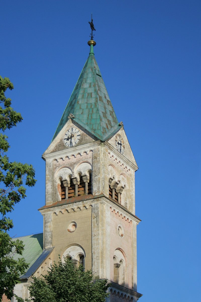a tall clock tower with a green top