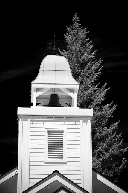 an ornate white church steeple at night