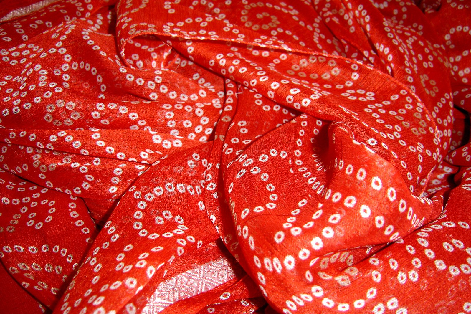 closeup of a red patterned cloth with white and red dots