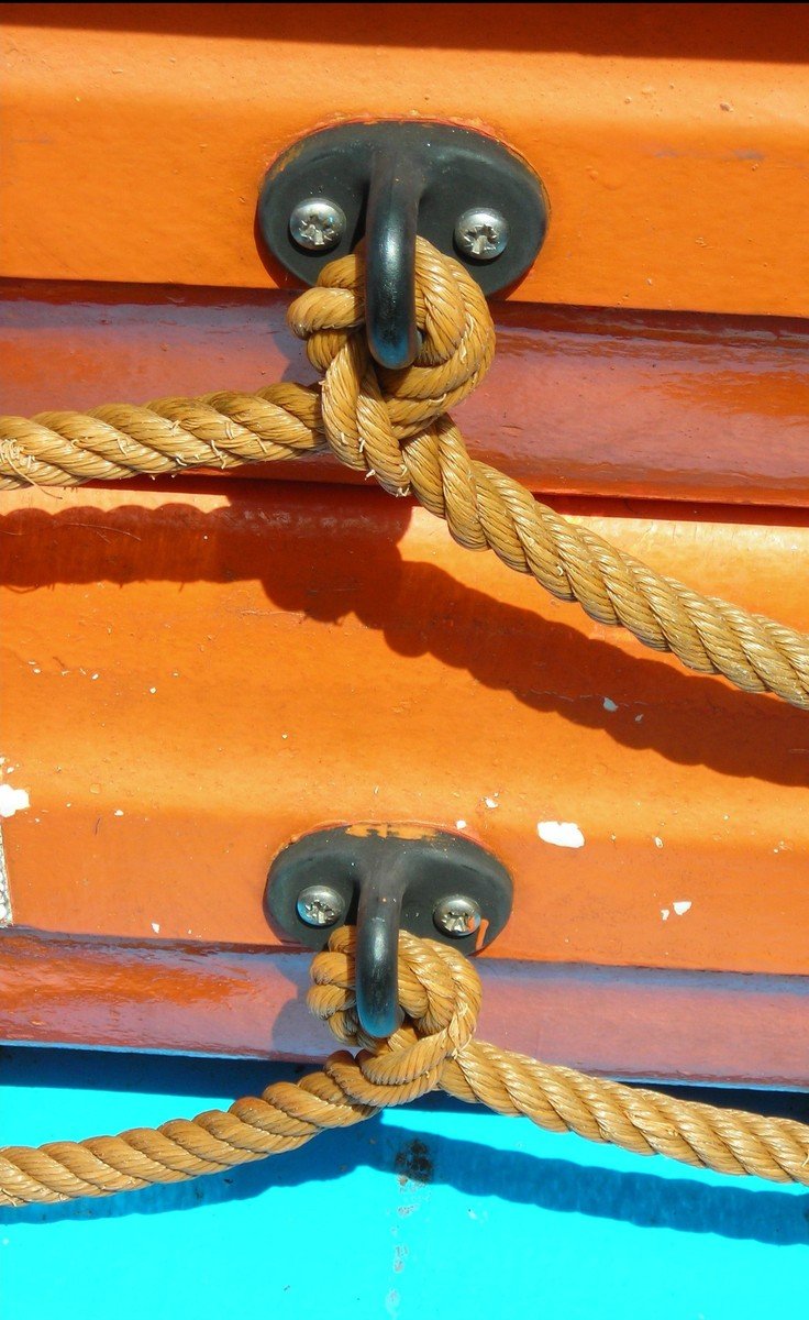 ropes connected to the bottom end of a boat