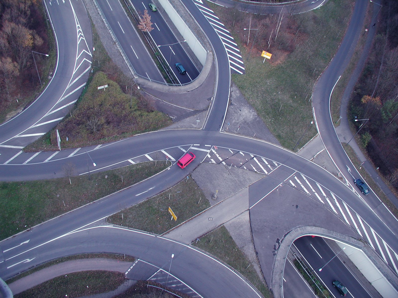 several cars are travelling on the highways next to each other