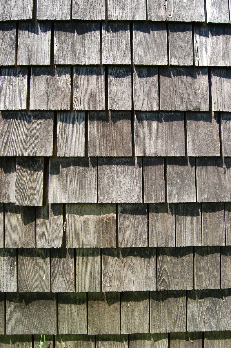 brown roof with a white dog lying under it