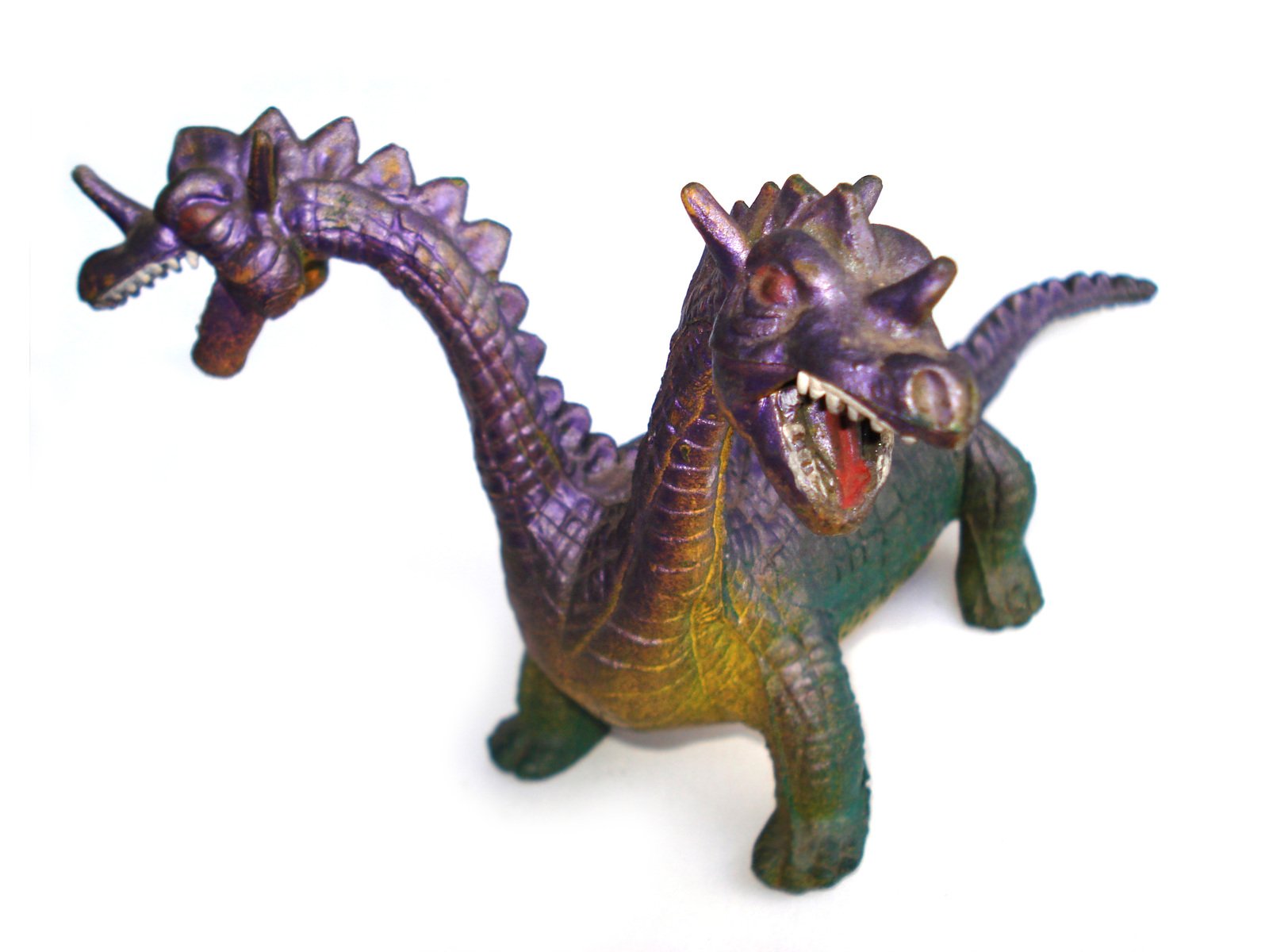 there is a small toy dinosaur with its teeth