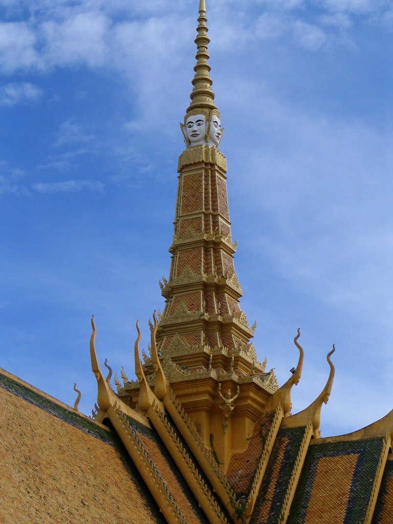 a gold tower with white face and horns