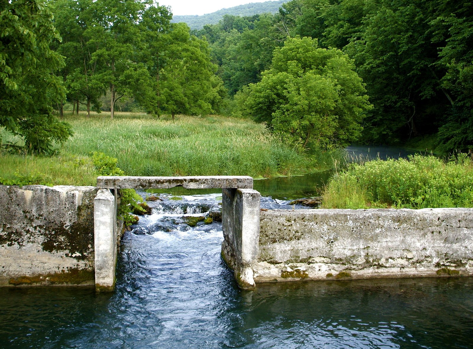 a stone bridge over a rushing river