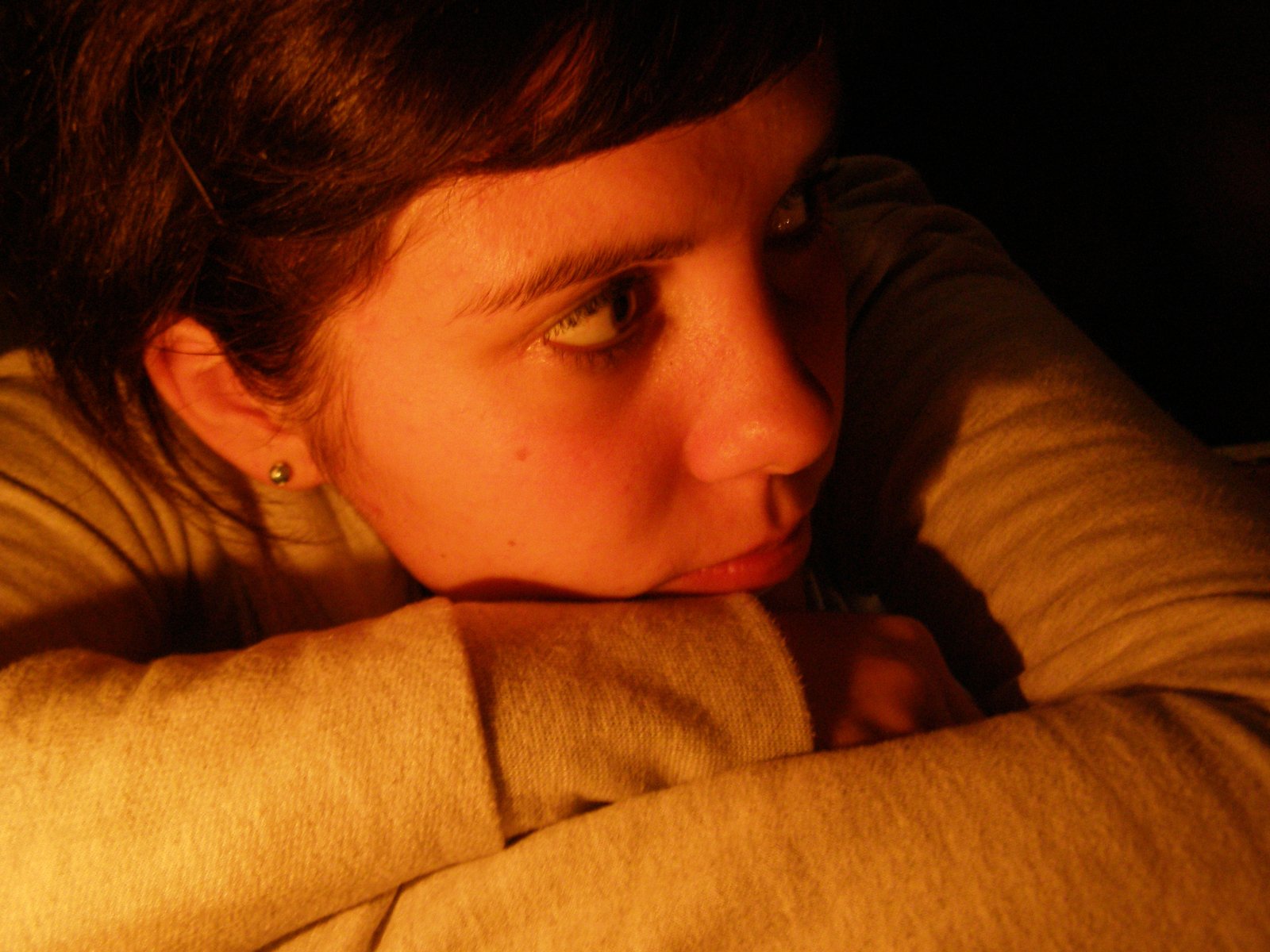 a woman staring up with one hand behind her head