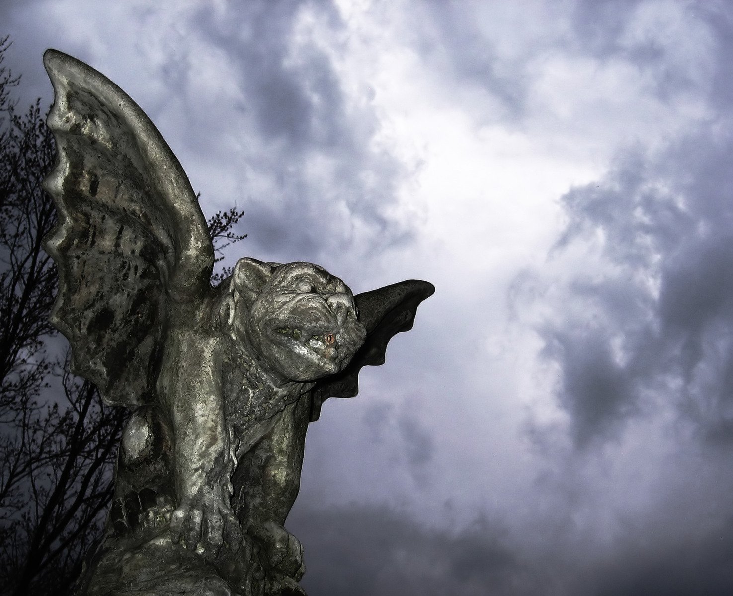 an elaborately decorated statue beneath a stormy sky