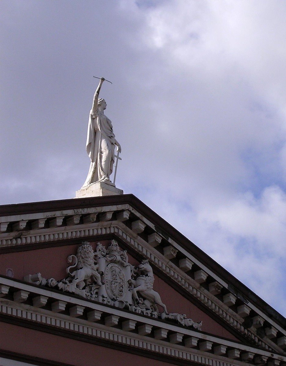 a large statue sitting on top of a building