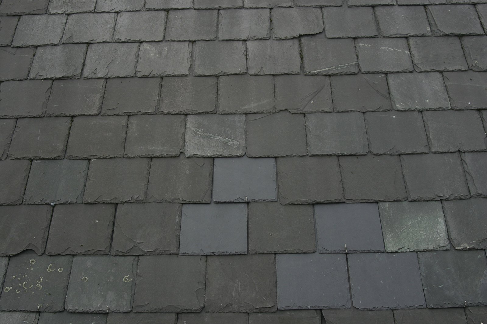 a gray slate roof with no leaks and broken tiles