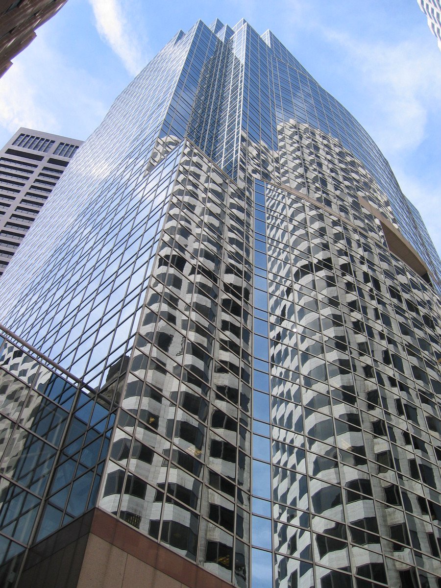 a group of large buildings are viewed from below