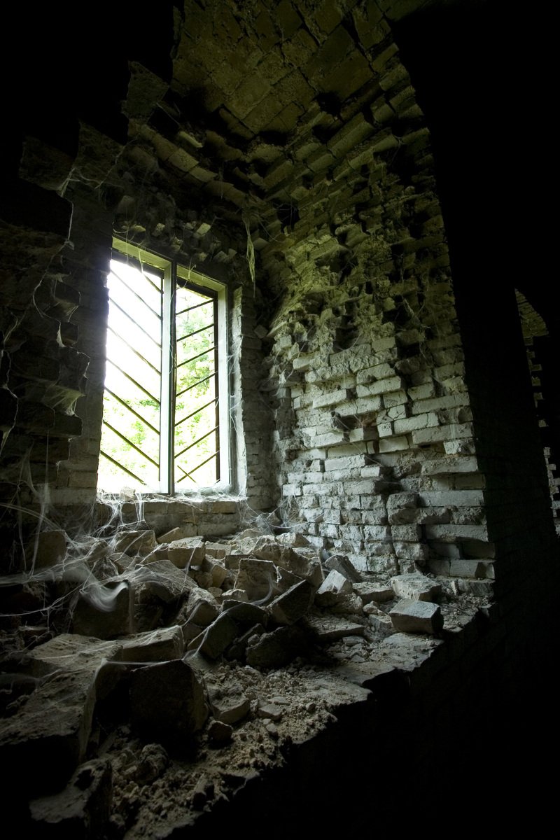 a very big and old looking window in a house