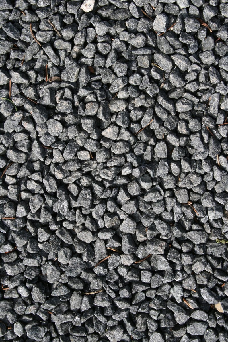 there is a black rock field and the rocks are black and grey