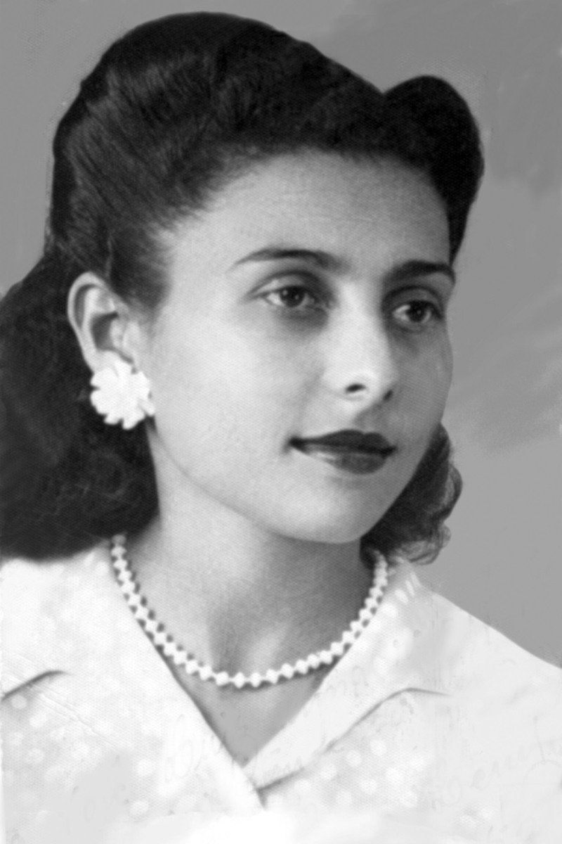 a black and white po of a woman wearing pearls