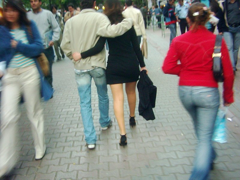 two young people walking down a city street