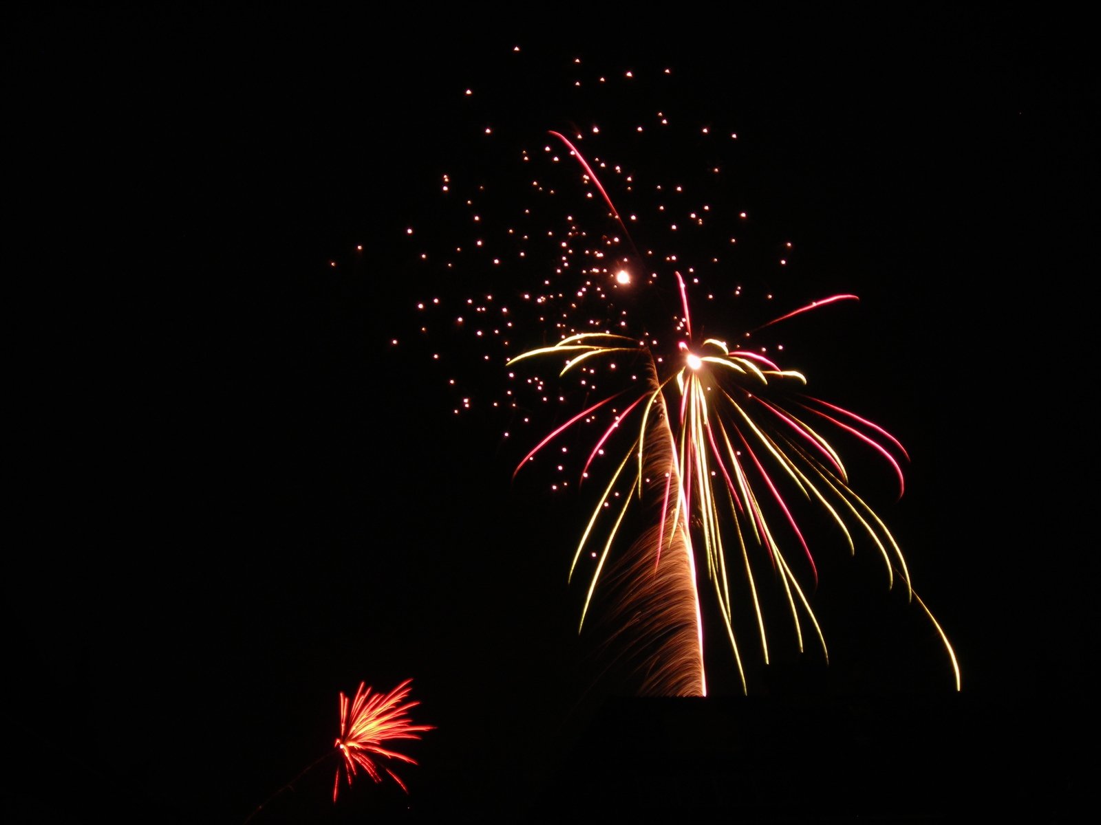 a large clock tower with fireworks on top