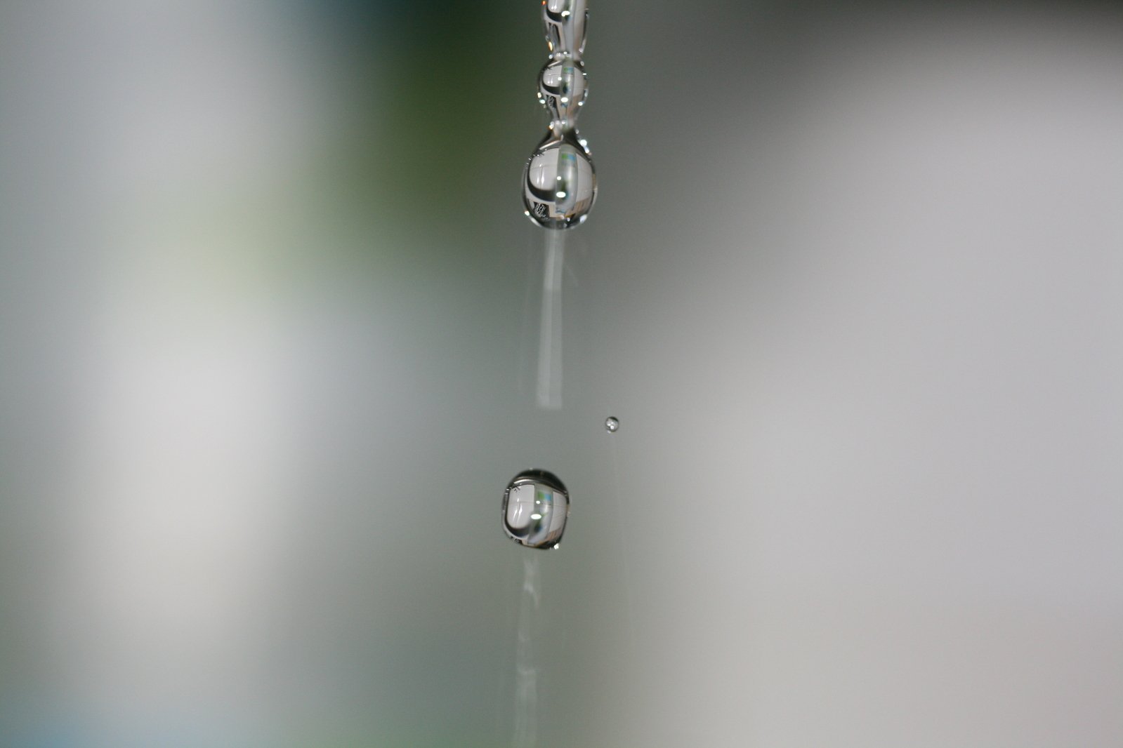 water droplets hanging from a rain gutter