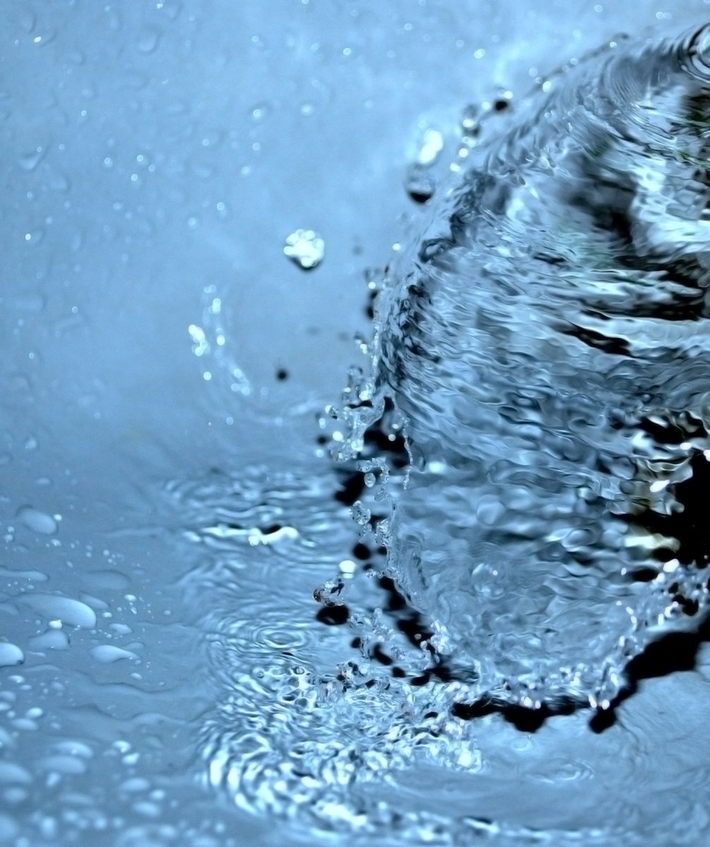 a close up of a sink with lots of water coming out