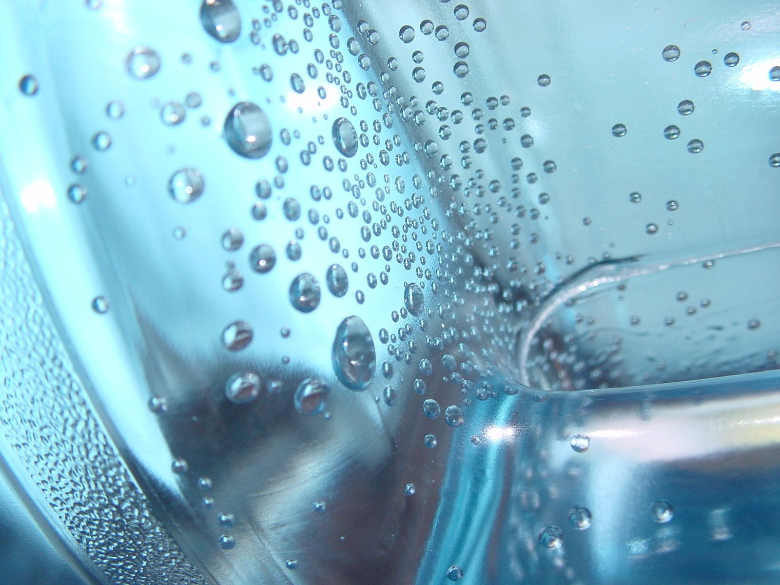 the bubbles are coming out of a large, glass bottle