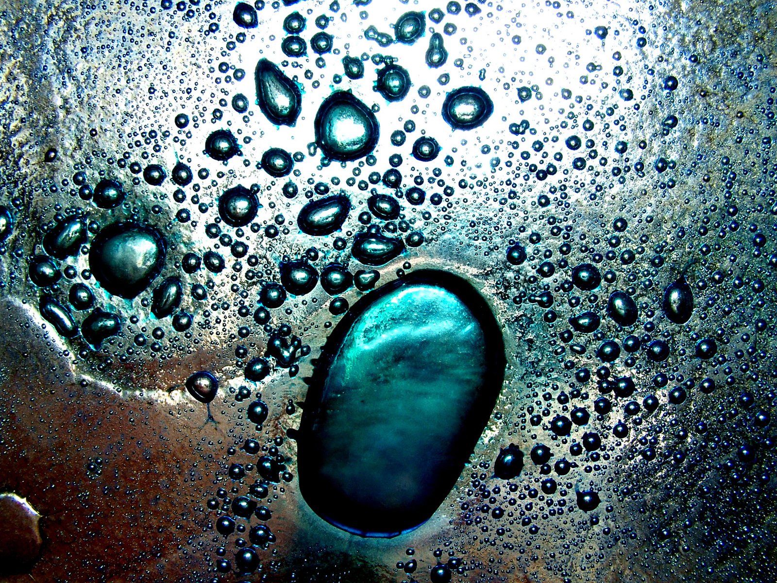 water droplets on glass with green tip