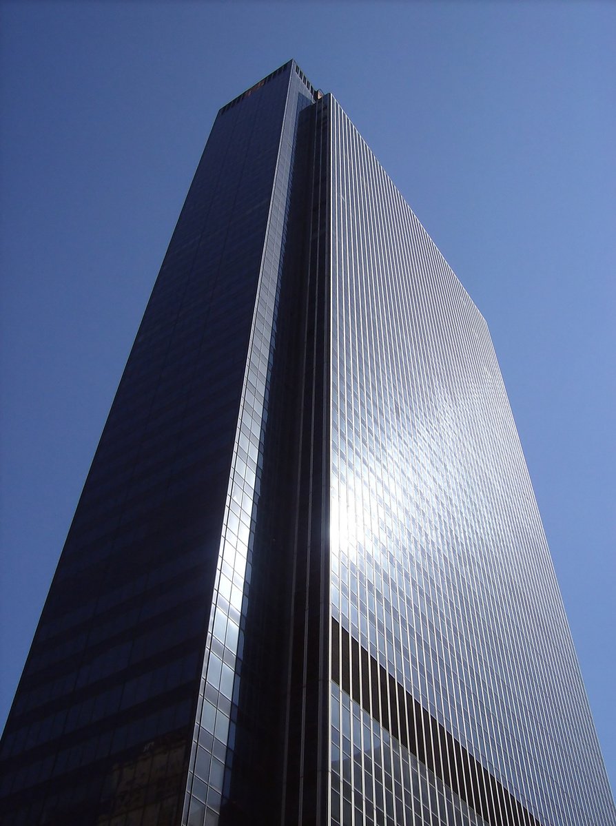 a tall glass building standing in the sun