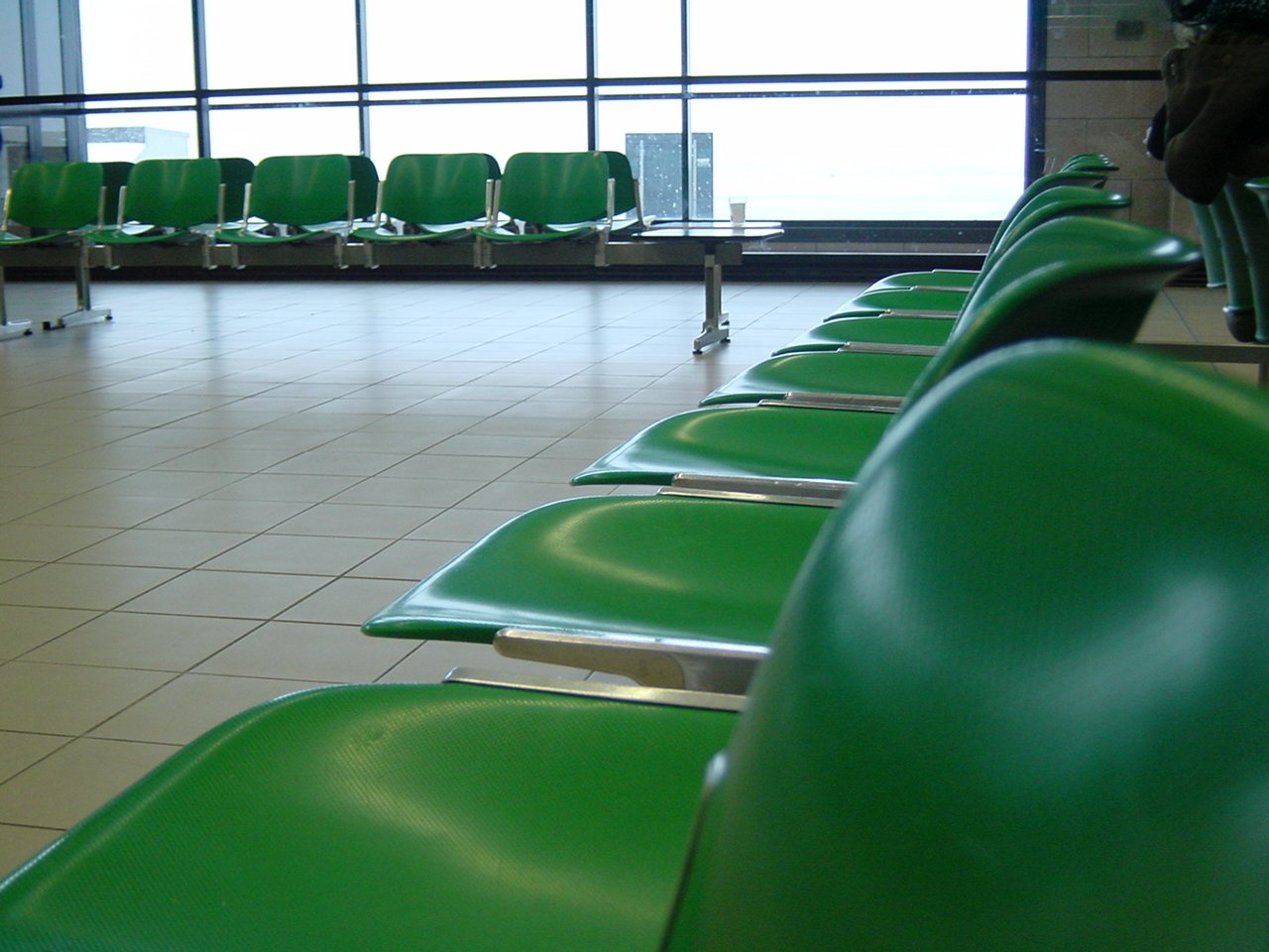 a line of empty chairs in an airport