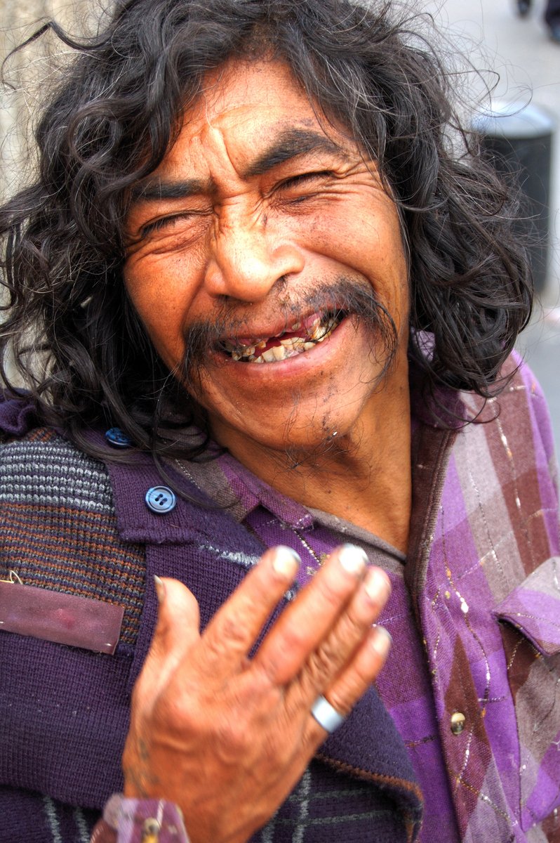 a man with long hair and a mustache is making a funny face