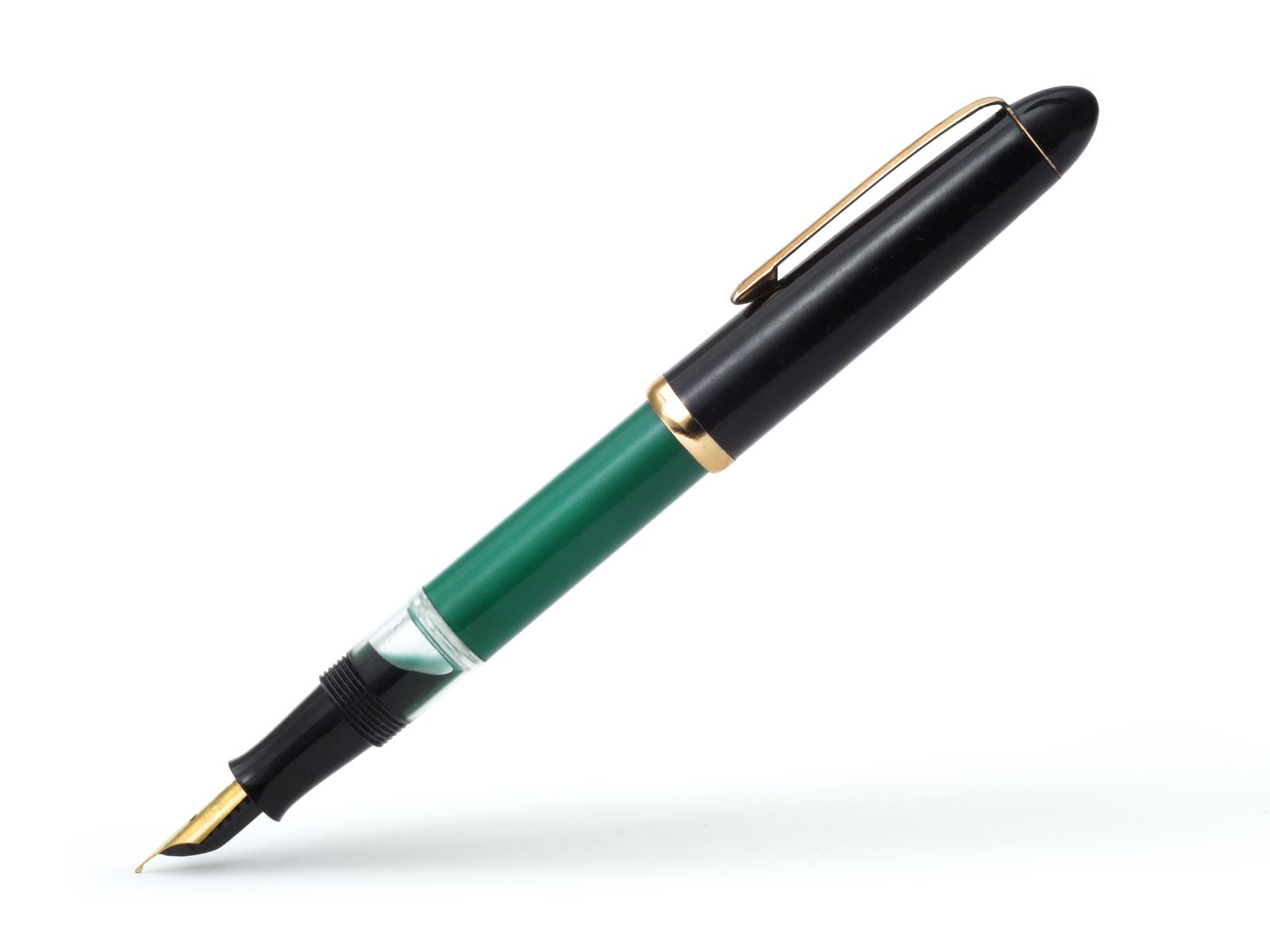 a green and gold fountain pen with its cap off