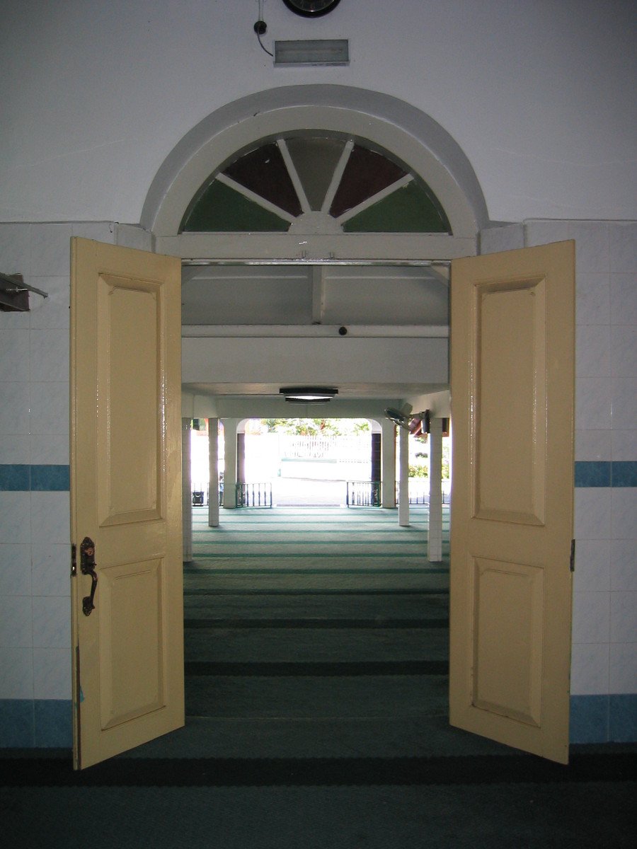 open doors leading into the hallway leading out onto the street