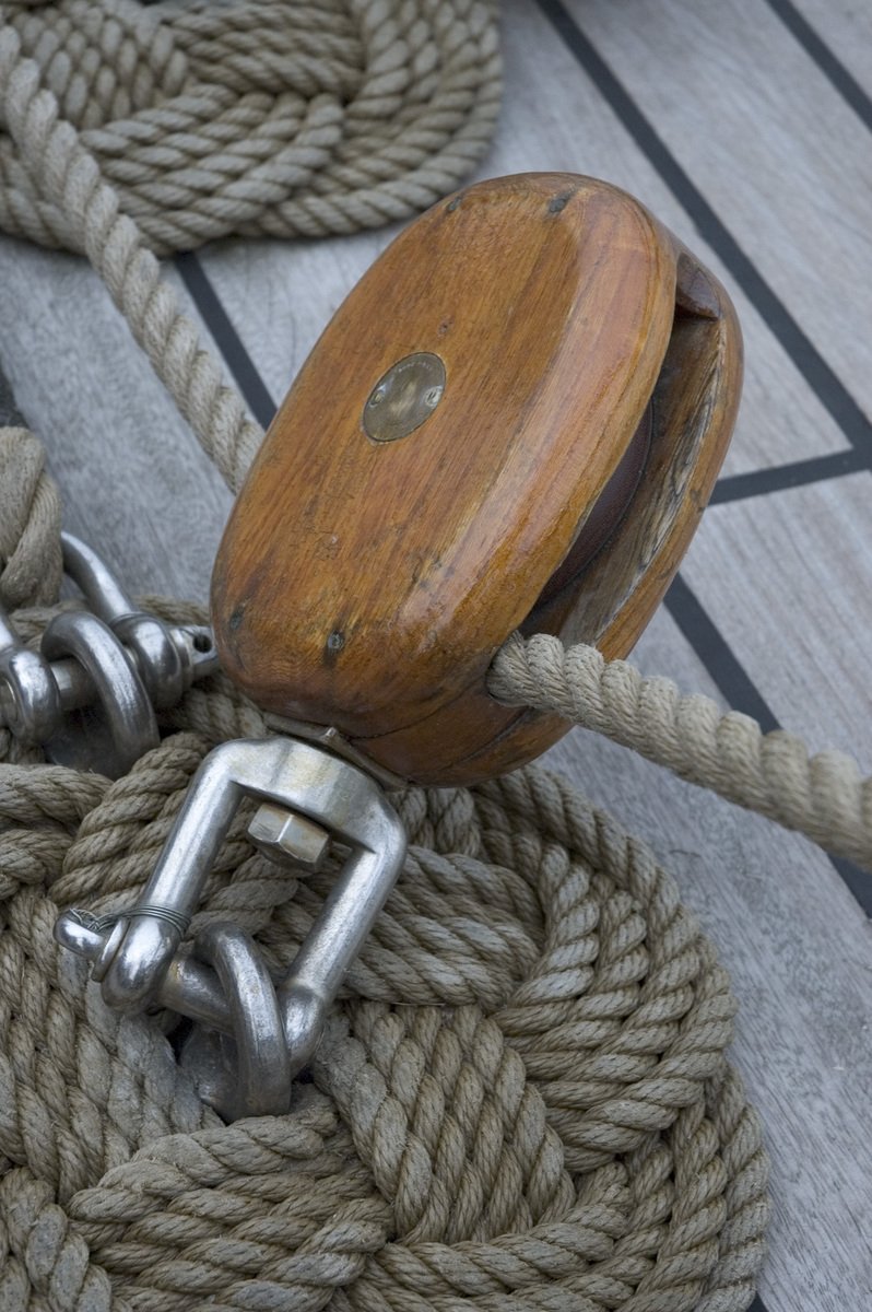 a wooden bell attached to ropes on a boat
