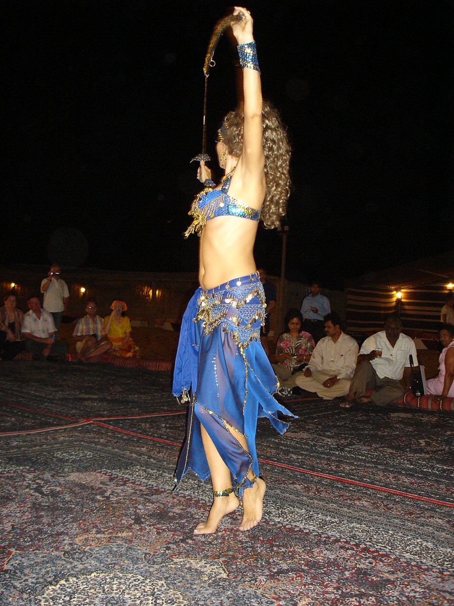 a belly dancer standing on her hip while performing