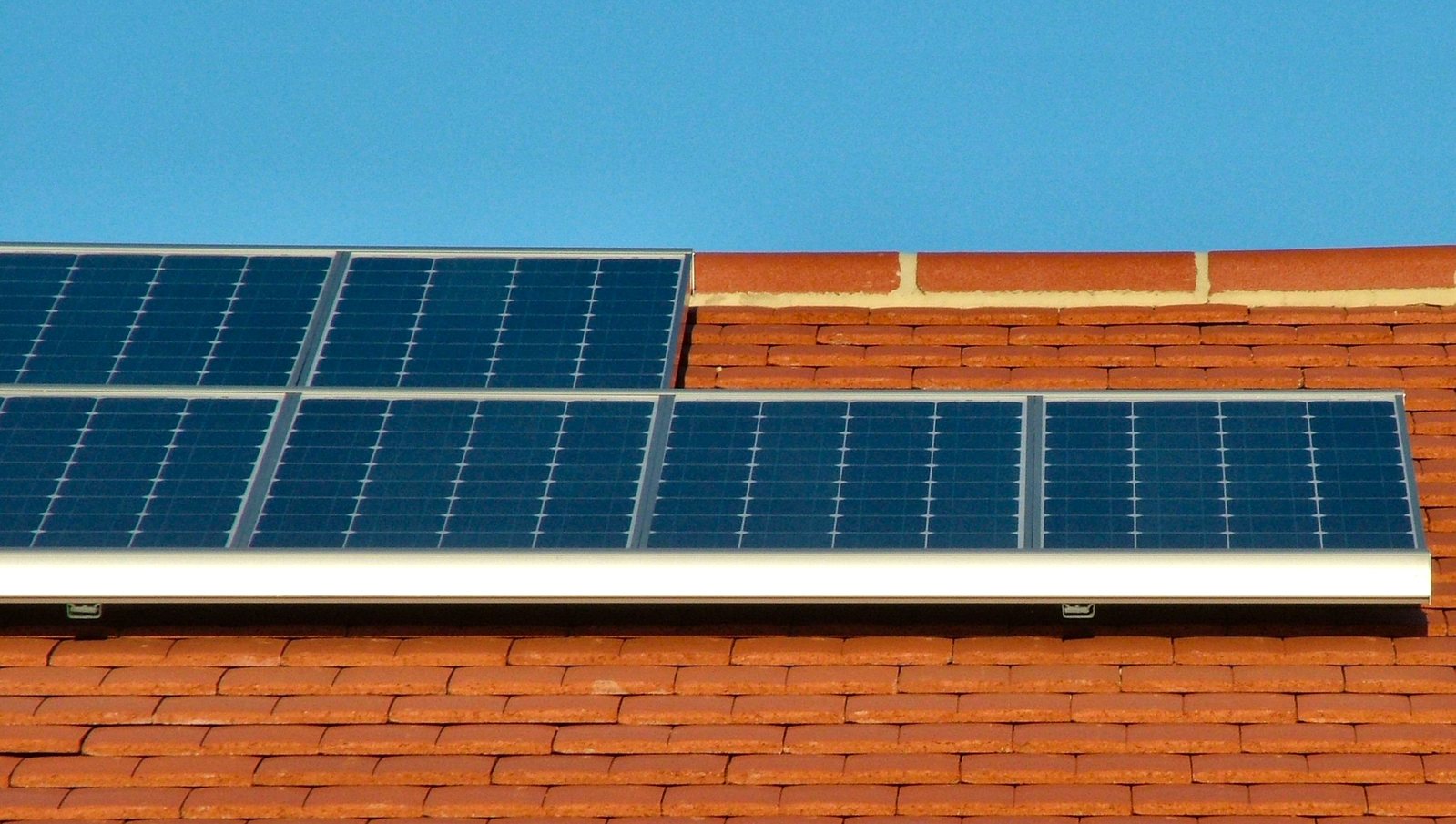 solar panels attached to the roof of a brick building