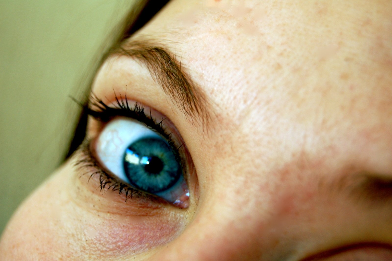 the woman's eye is showing with a blue ring