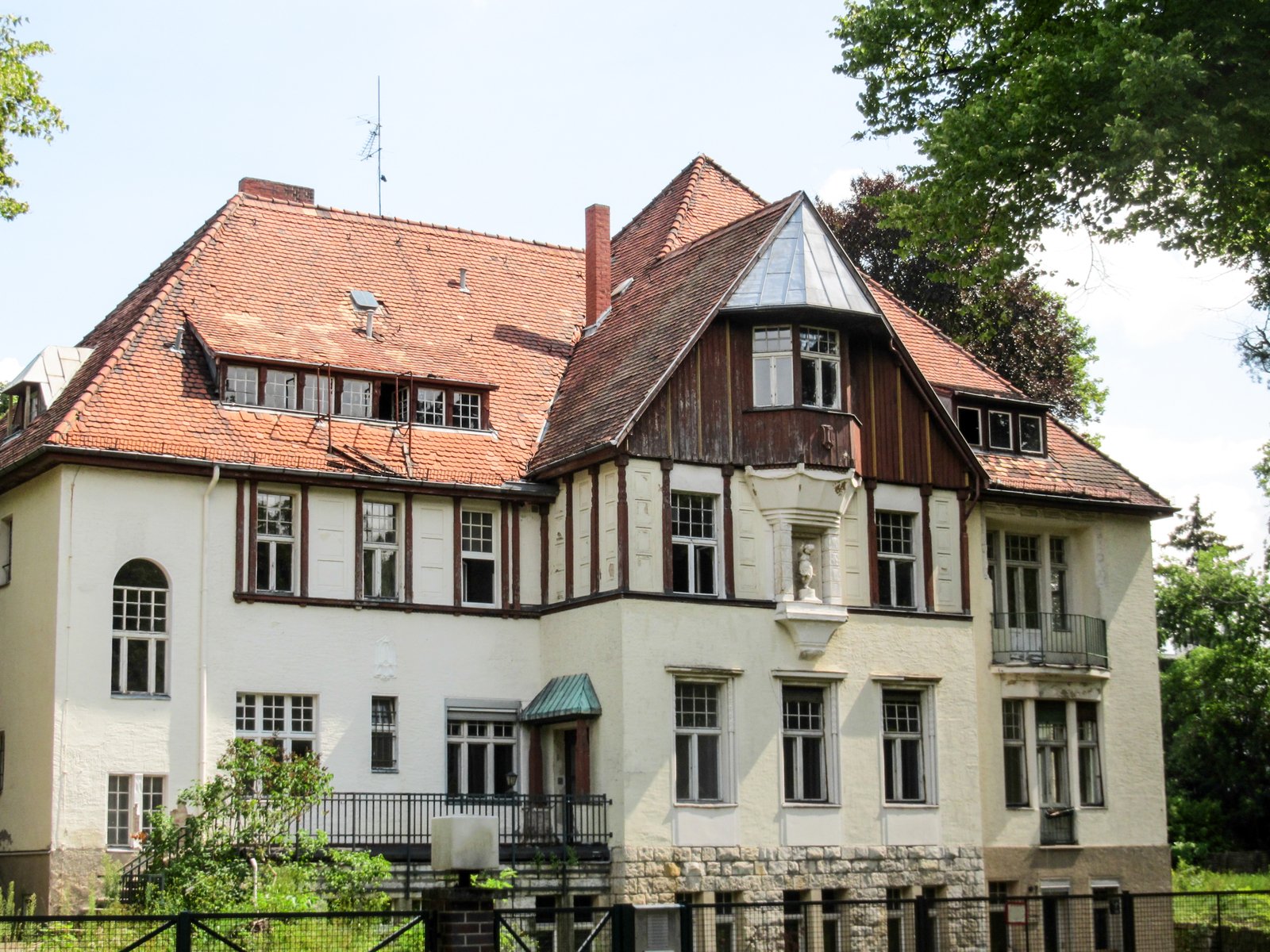 an old house is white with brown trim