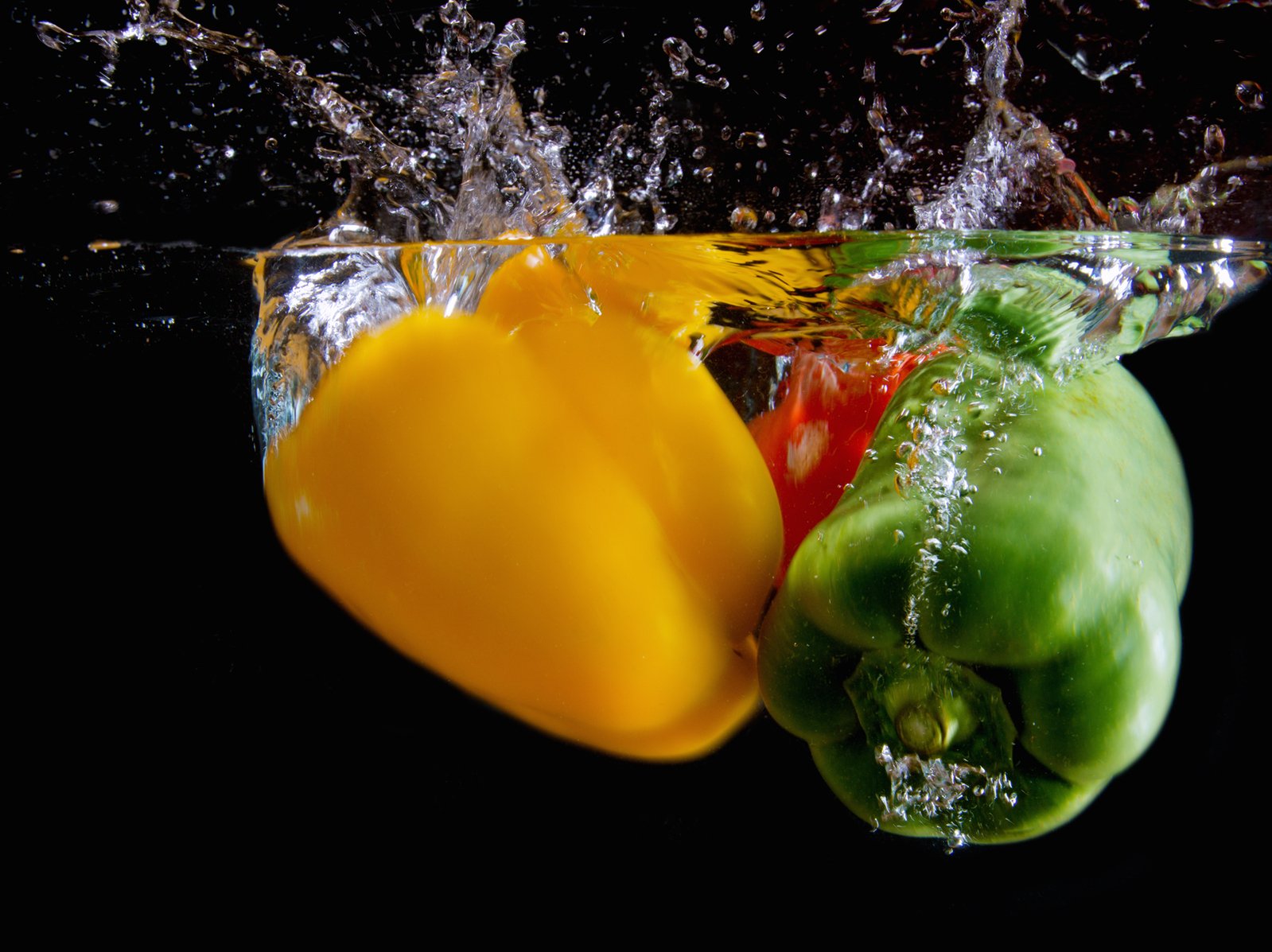 colorful peppers in the water making a splash