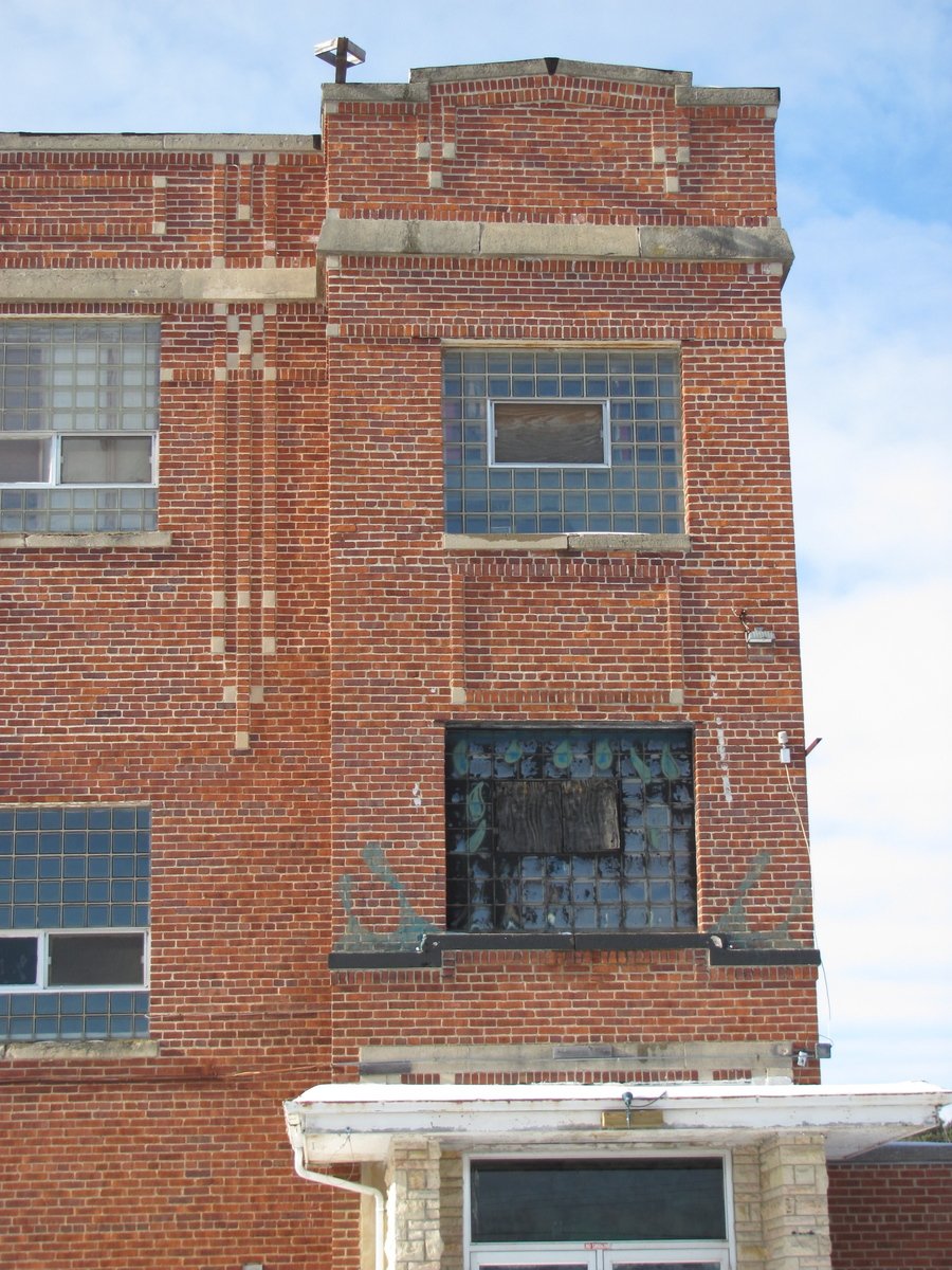 a tall brick building with a clock on it