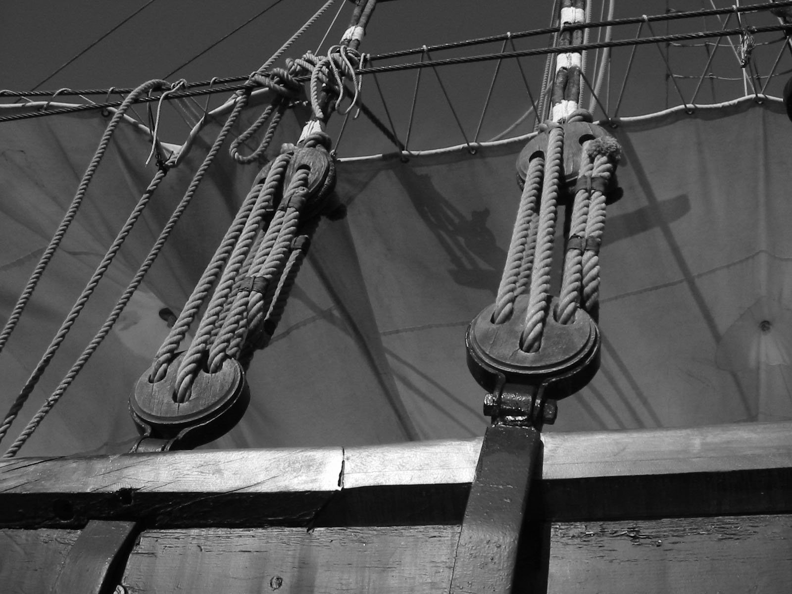 ropes and wires on top of an old sailboat