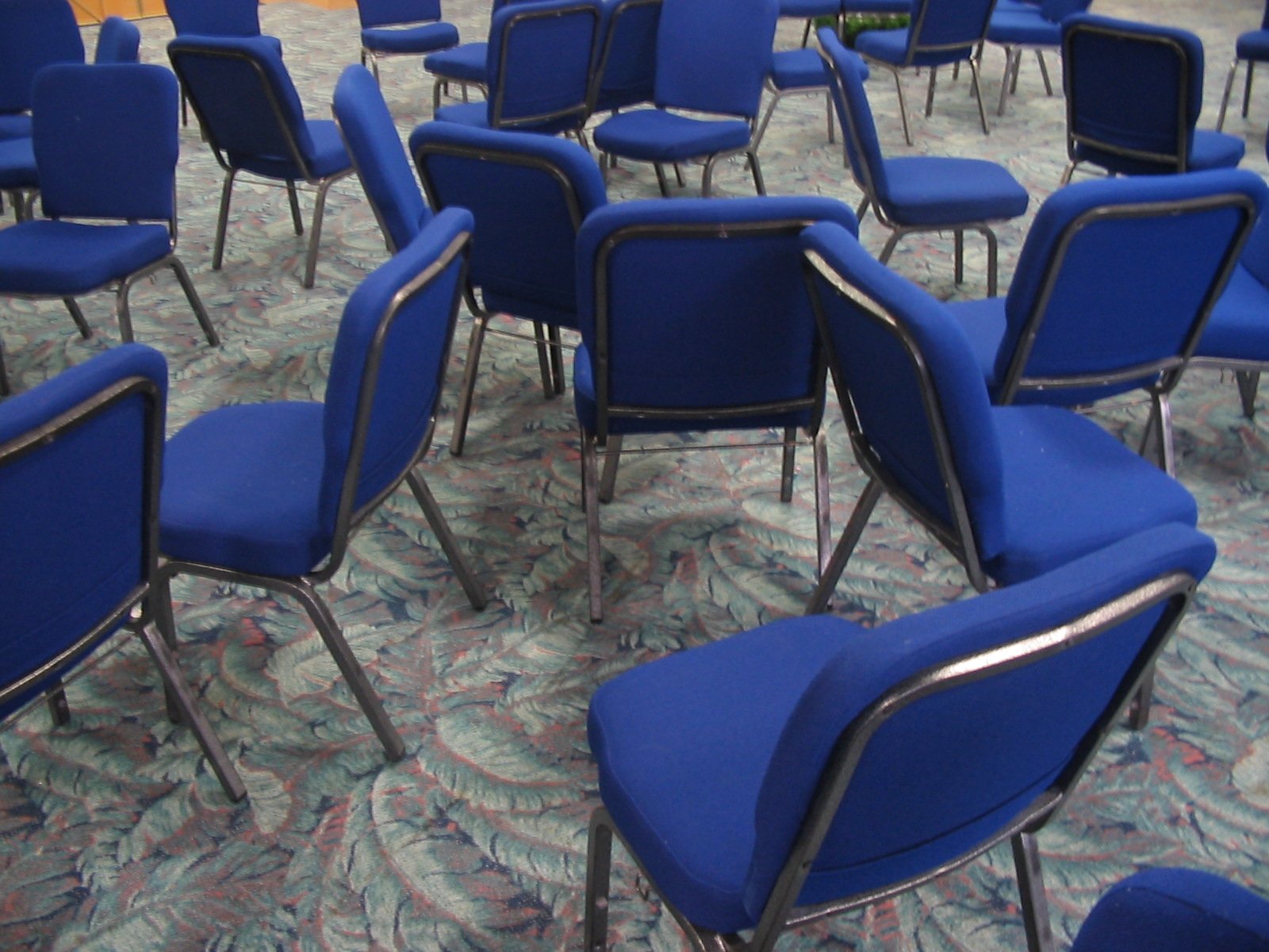 an arrangement of blue chairs in a room