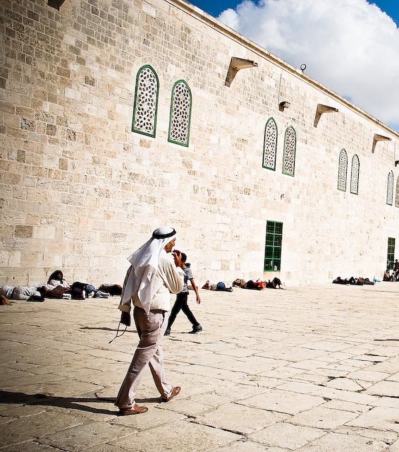 a man walking with other men in the background