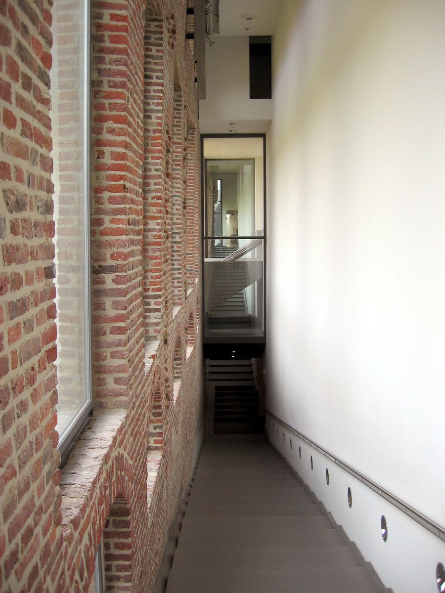 the hallway is made from bricks on both sides