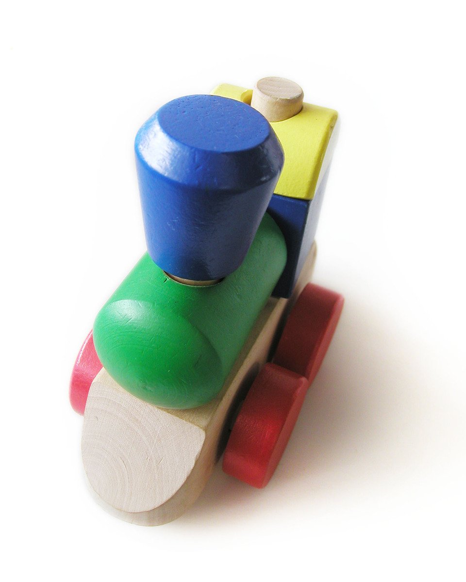 a wooden toy train sitting on top of a white table