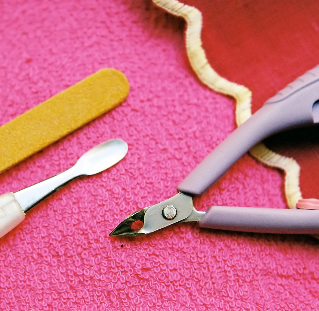 a pair of scissors on the floor next to a piece of fabric