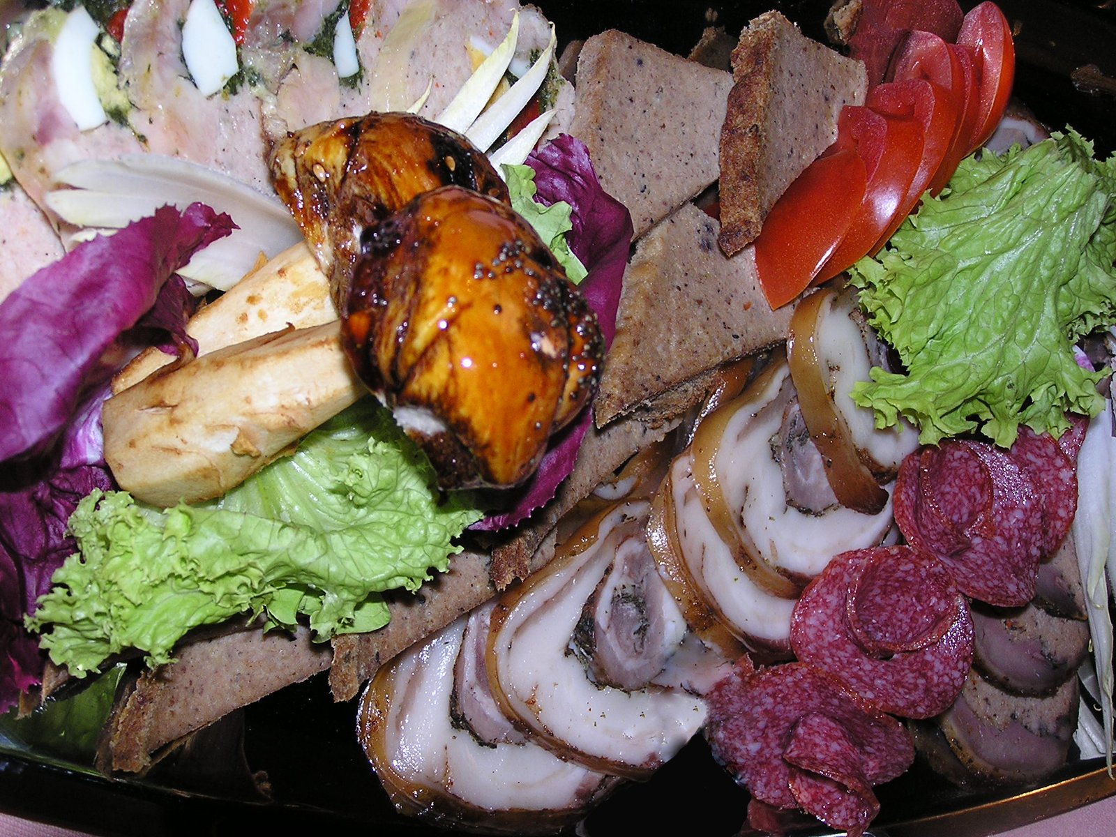 a table topped with lots of food and meats