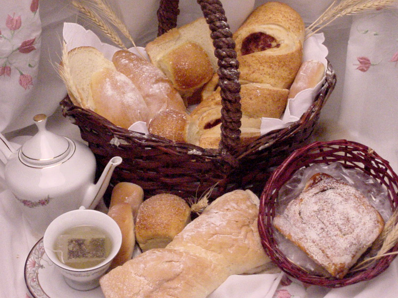 a table with different kinds of bread in baskets on it