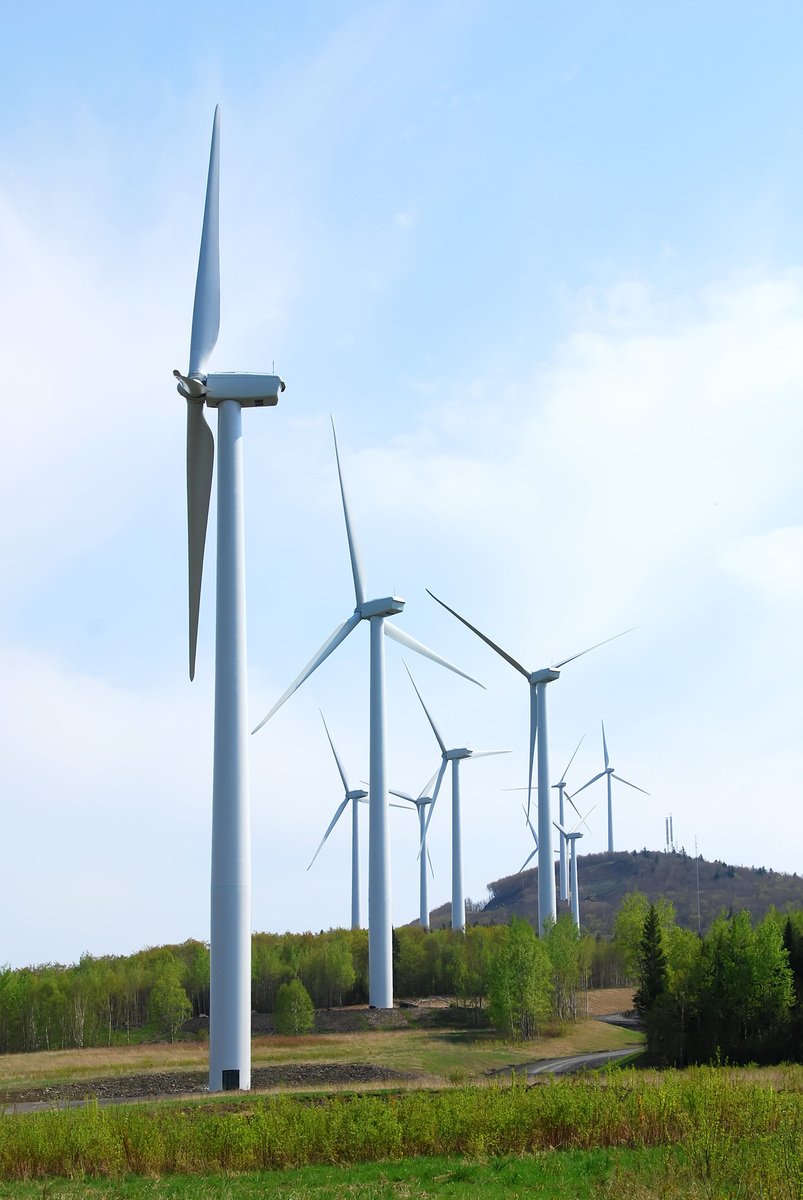 four large windmills sitting in the middle of a field