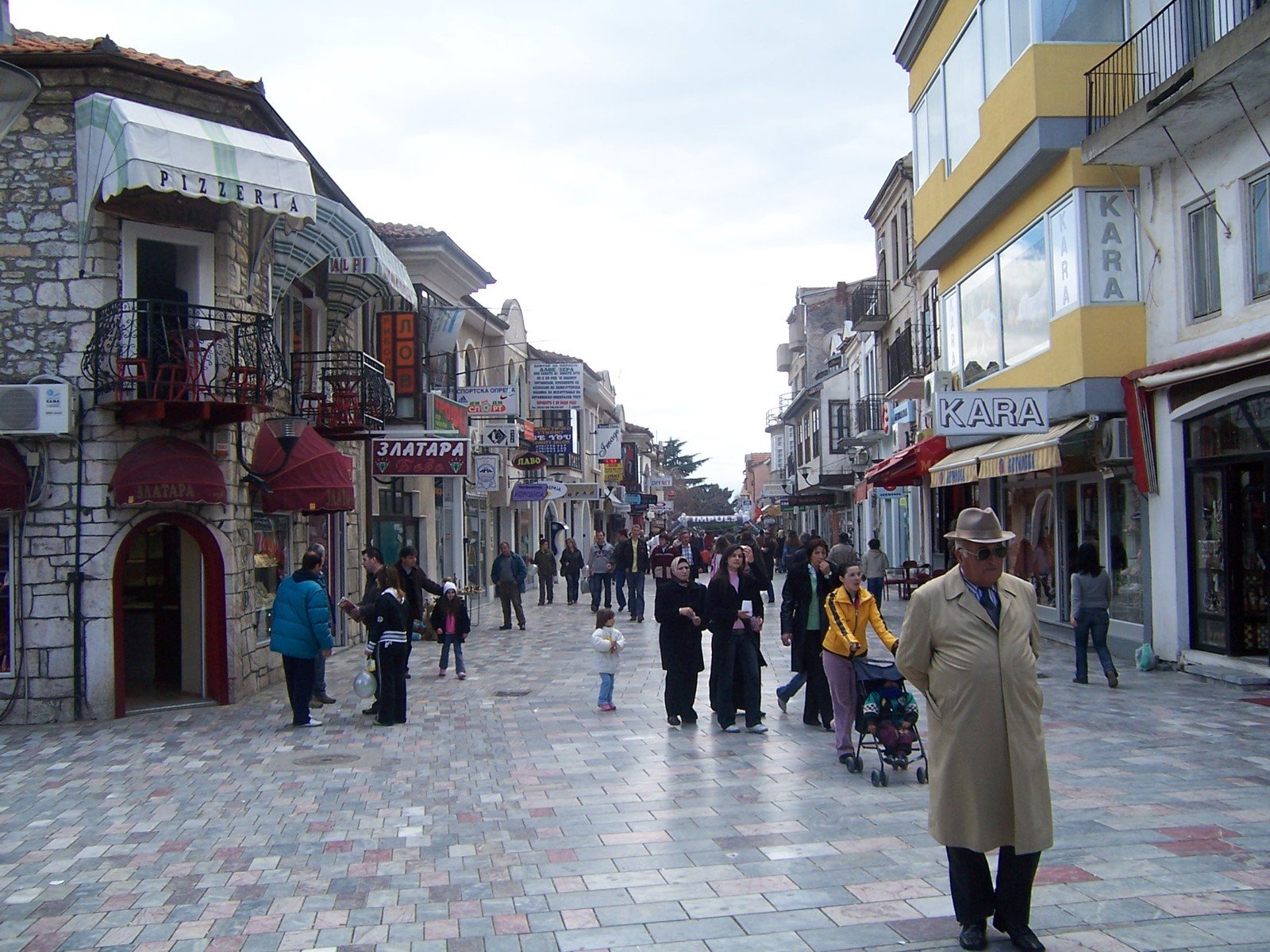 a lot of people walk down an empty street