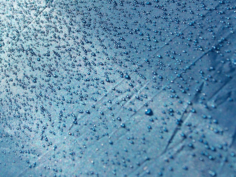 the outside of a car's windshield, with rain drops on it