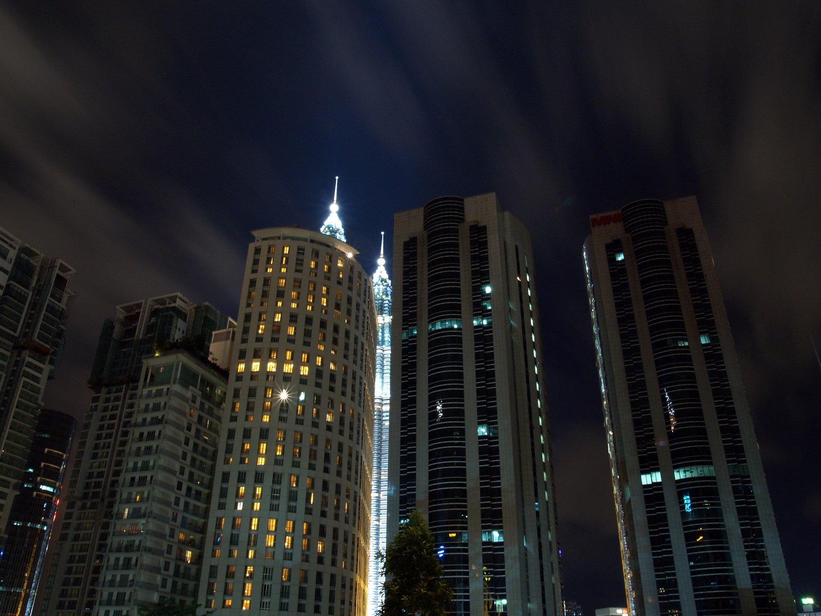 several buildings on an urban night sky line