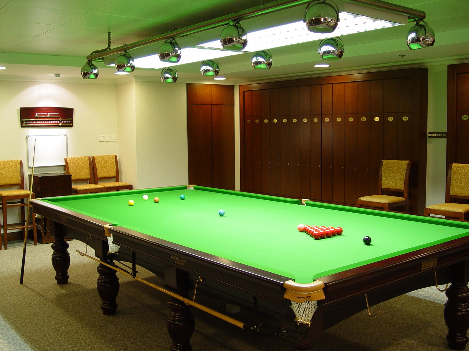 an entertainment room with a pool table and several chairs