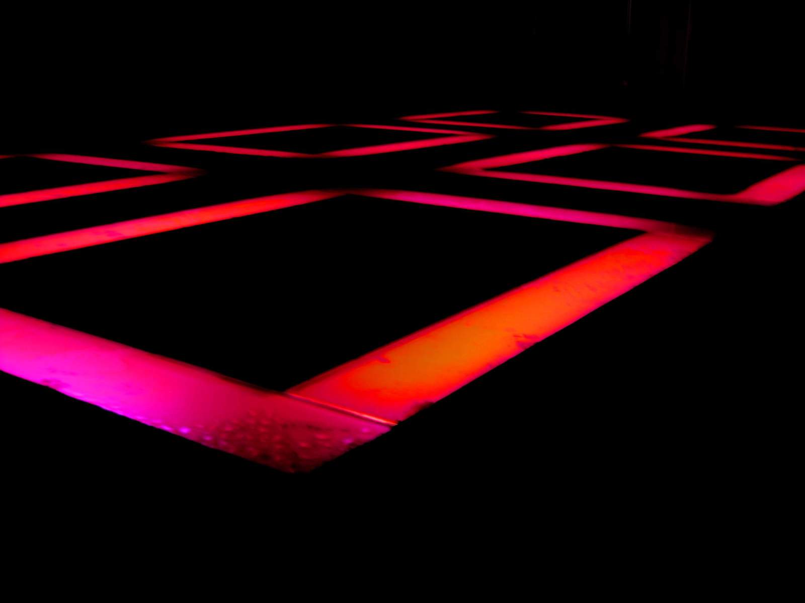 an artistic neon dance floor with squares and dots on it