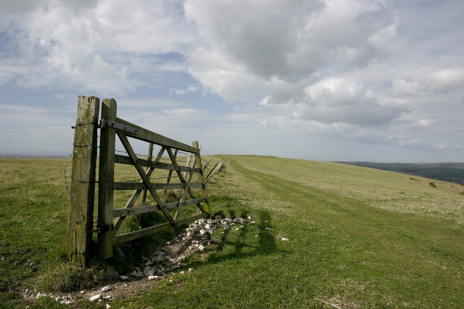 the gate to a small patch of grass on a hill